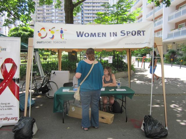 Interest at the Women's Booth - someone getting more information about how to get involved.